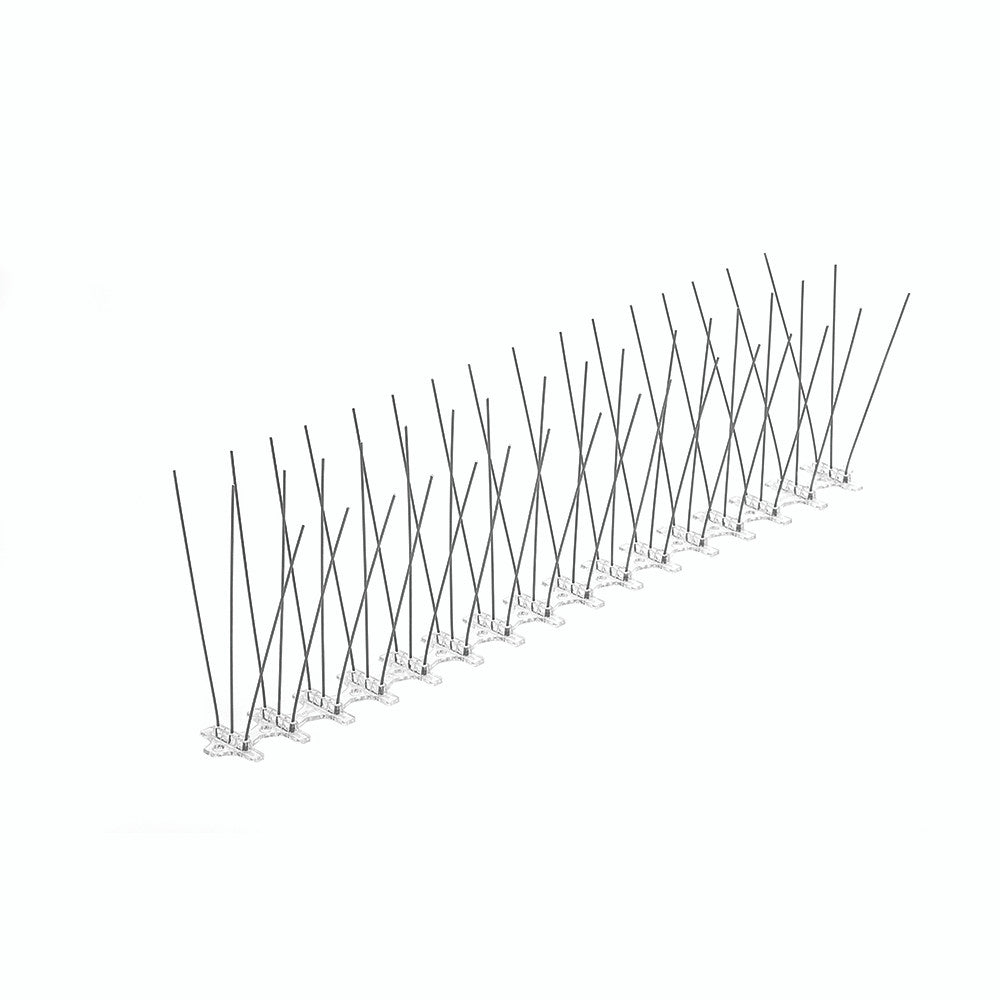 Row of black metal bird spikes on a white background