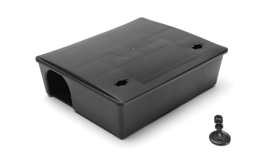 Low-profile rat bait station for livestock farms